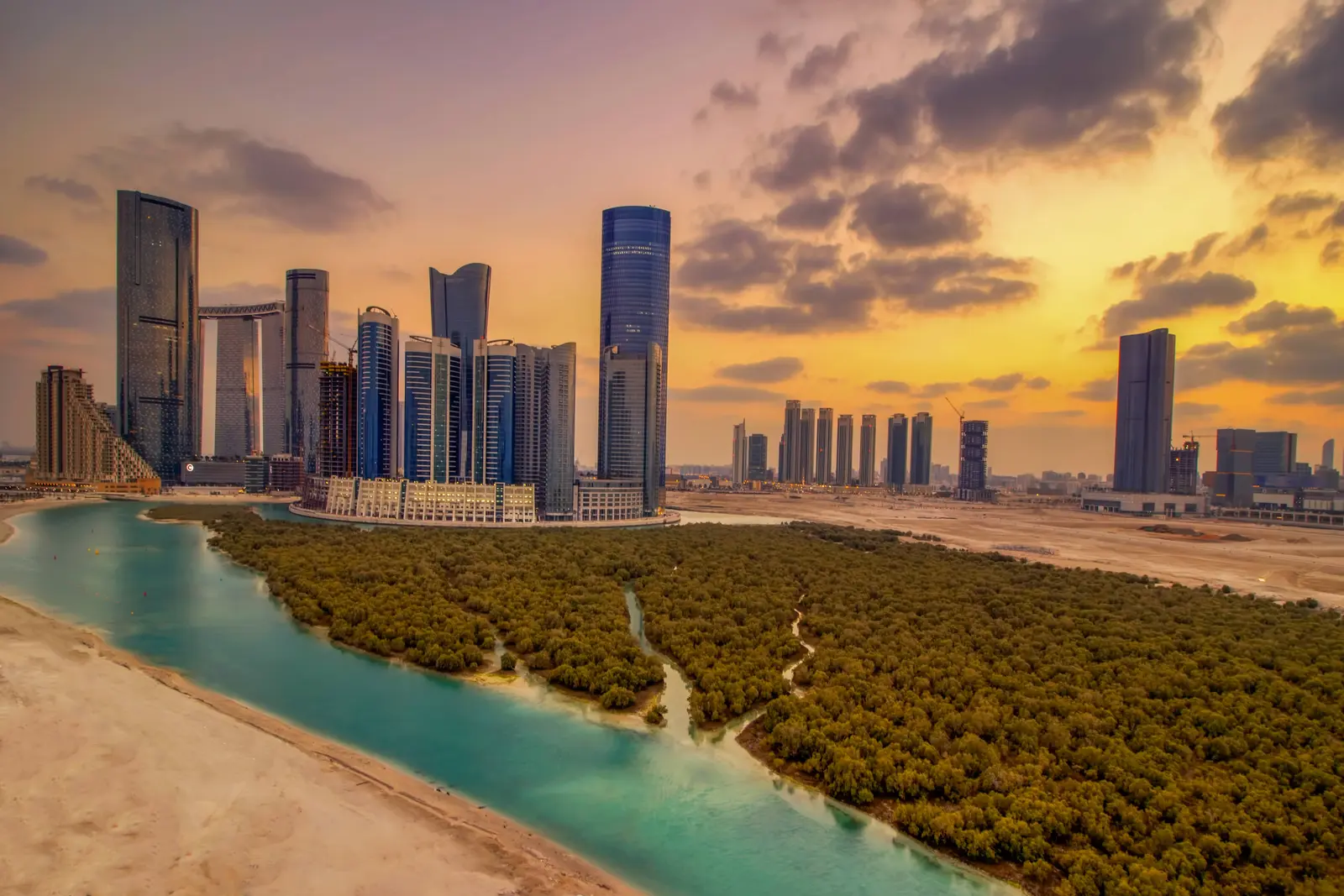 Modern glass exterior architecture of Marina Rise Tower in Al Reem Island Abu Dhabi with waterfront canal views.