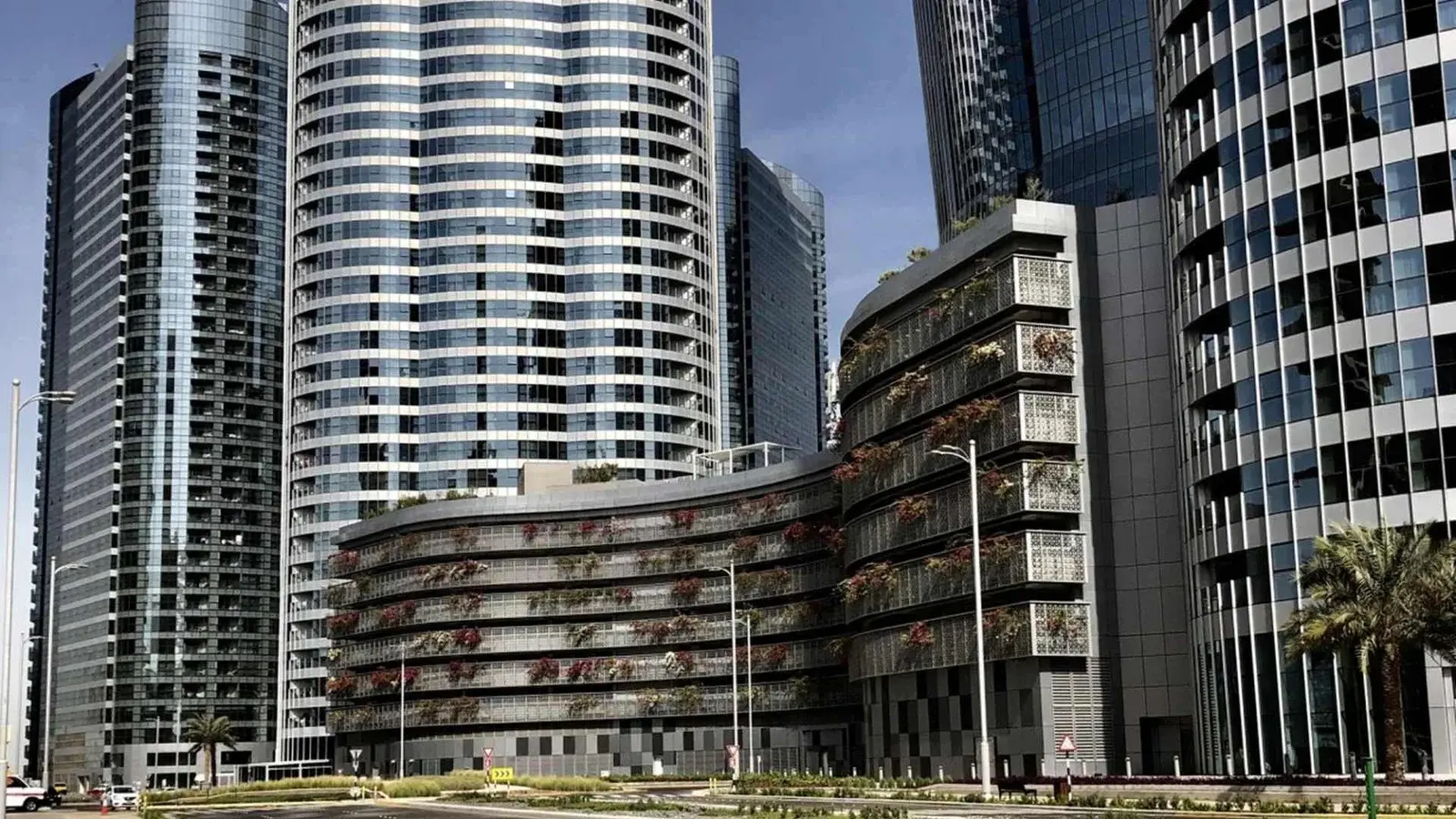 Aerial exterior of Omega Tower Al Reem Island Abu Dhabi set within the Solaris Towers complex and wider island skyline