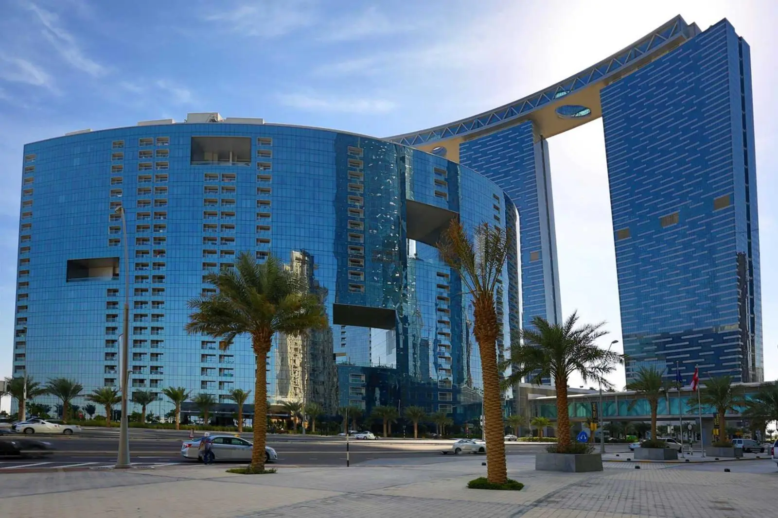Iconic semi-circular exterior architecture of The Arc Tower within the Gate Towers complex, Shams Abu Dhabi.