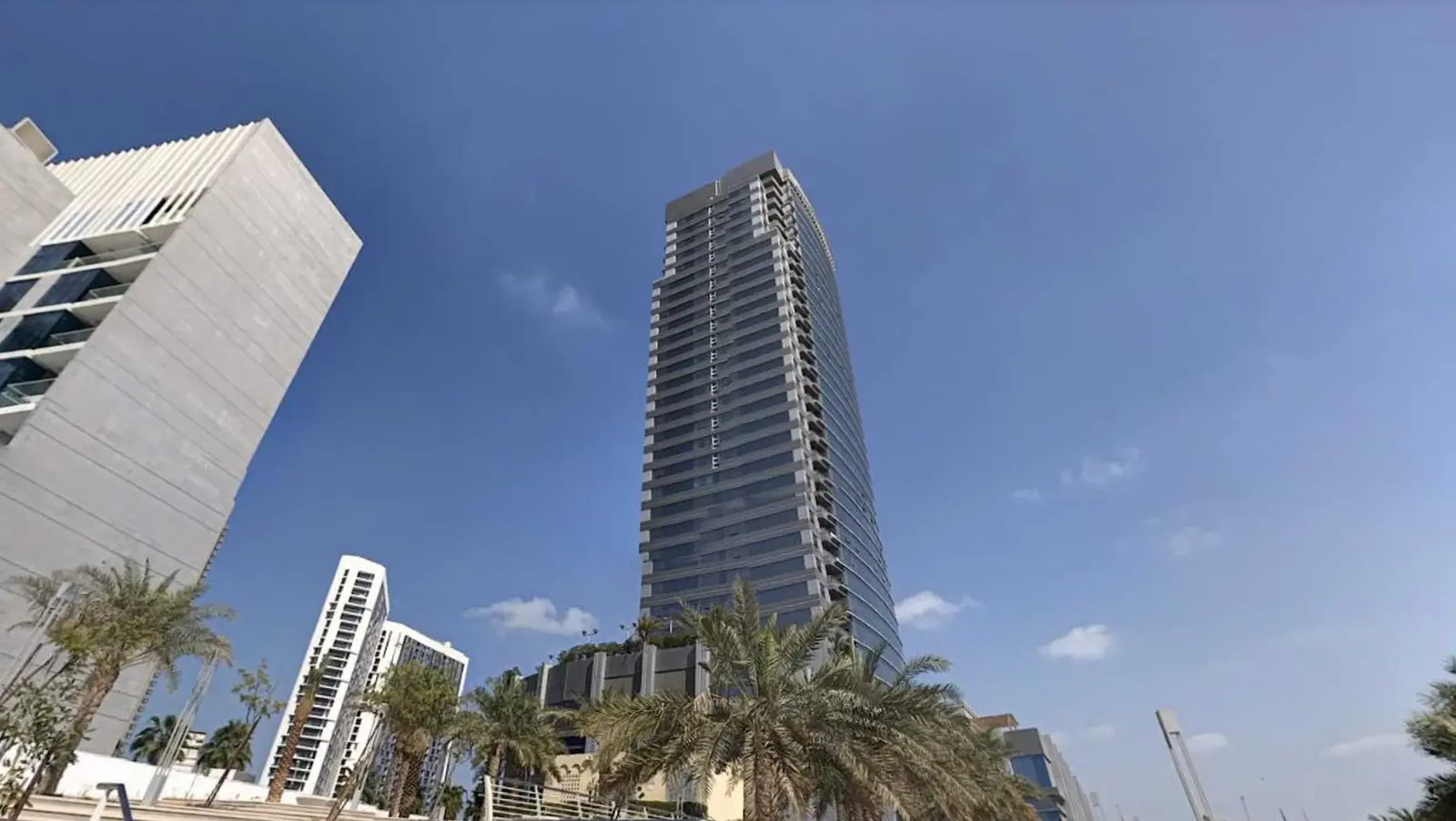High-rise coastal facade of Al Wifaq Tower featuring contemporary architectural design in Shams district on Al Reem Island, Abu Dhabi