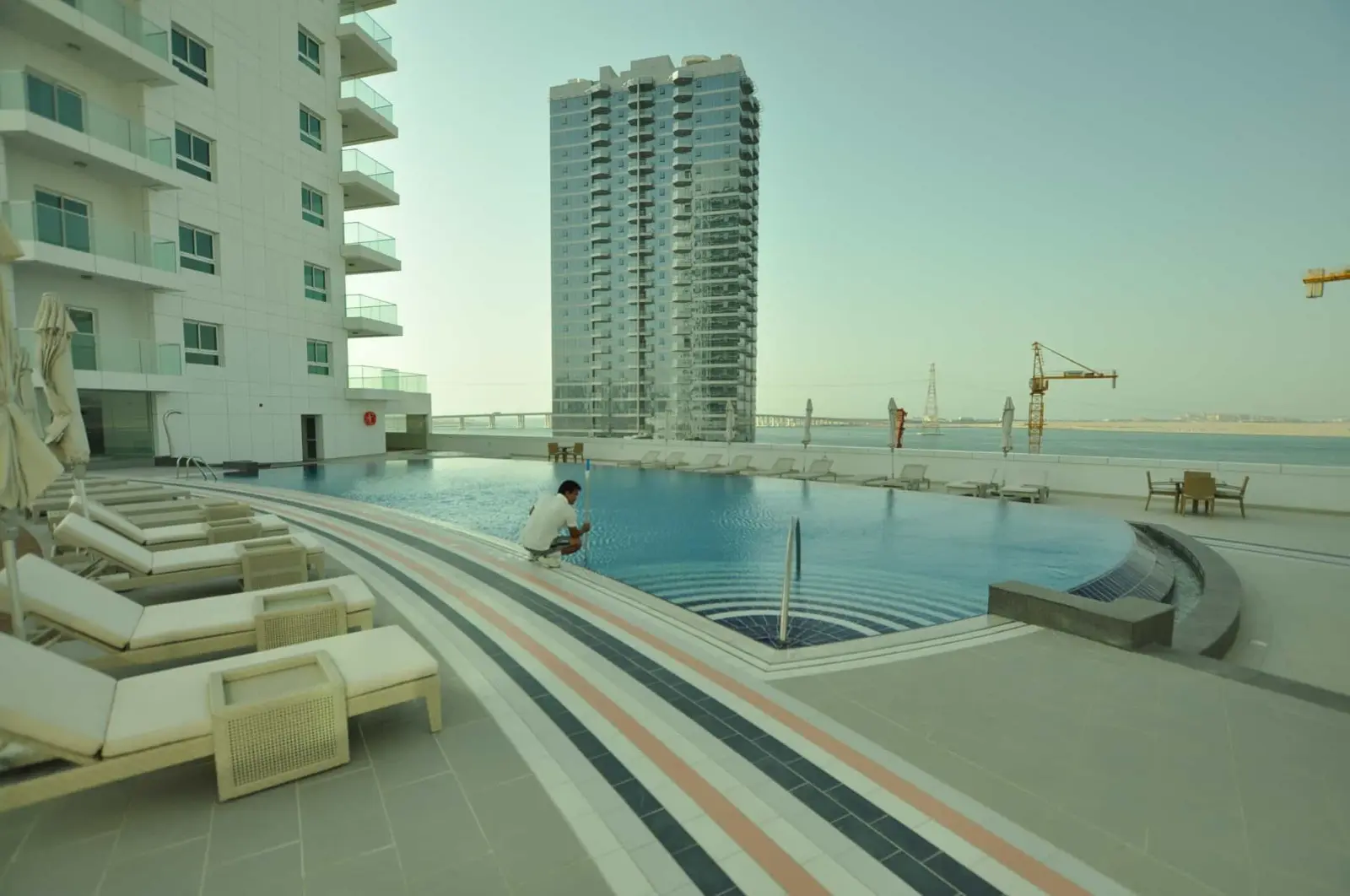 Contemporary fitted kitchen layout with granite countertops inside a ready apartment at Sea View Tower, Abu Dhabi.