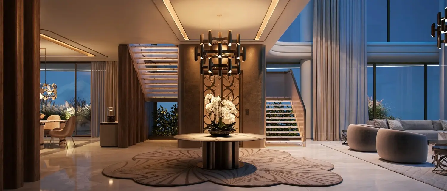 Premium apartment living room at Elie Saab Waterfront Abu Dhabi seamlessly connecting to a private panoramic glass balcony.