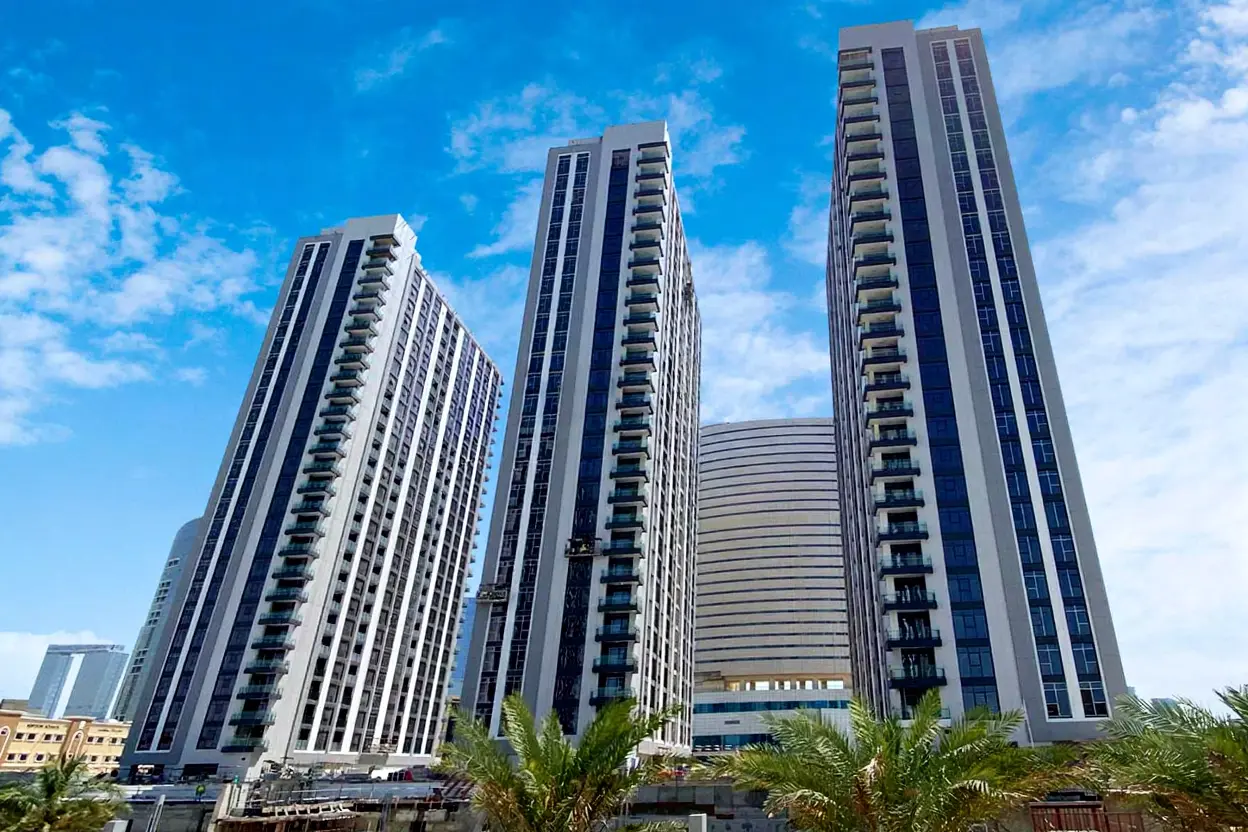 Canal promenade at The Bridges Reem Island highlighting waterfront walking paths and luxury apartment community living.
