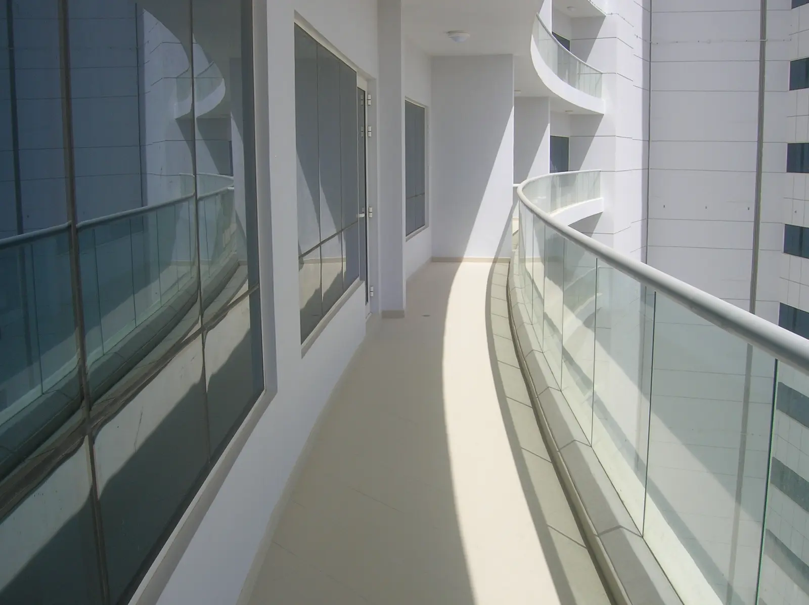 Oceanscape by Damac tower exterior at twilight on Al Reem Island, Abu Dhabi, illuminated against the city skyline
