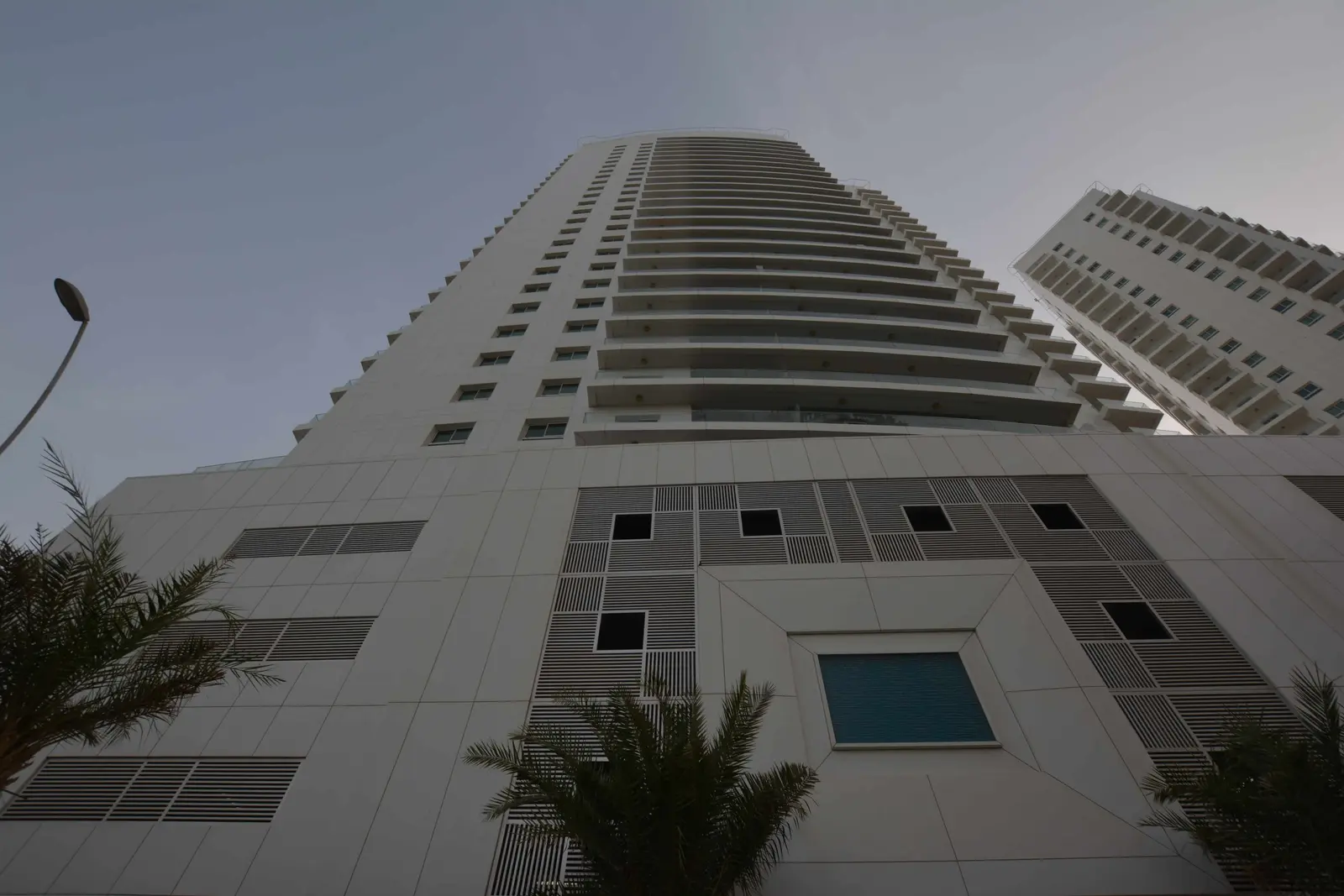 Modern residential exterior of Amaya Towers, Shams Abu Dhabi, Al Reem Island with landscaped podium and premium waterfront setting.