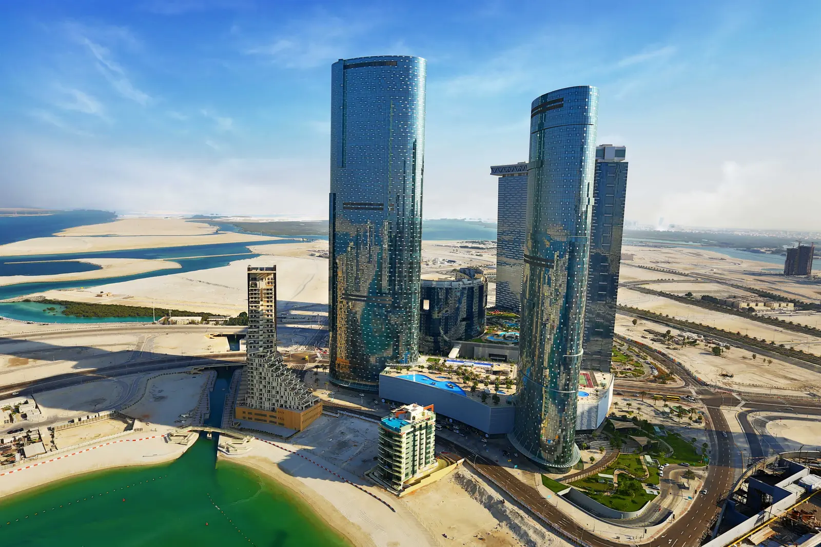 Sky Tower Al Reem Island Abu Dhabi 74‑storey tower illuminated at dusk with reflections across the waterfront