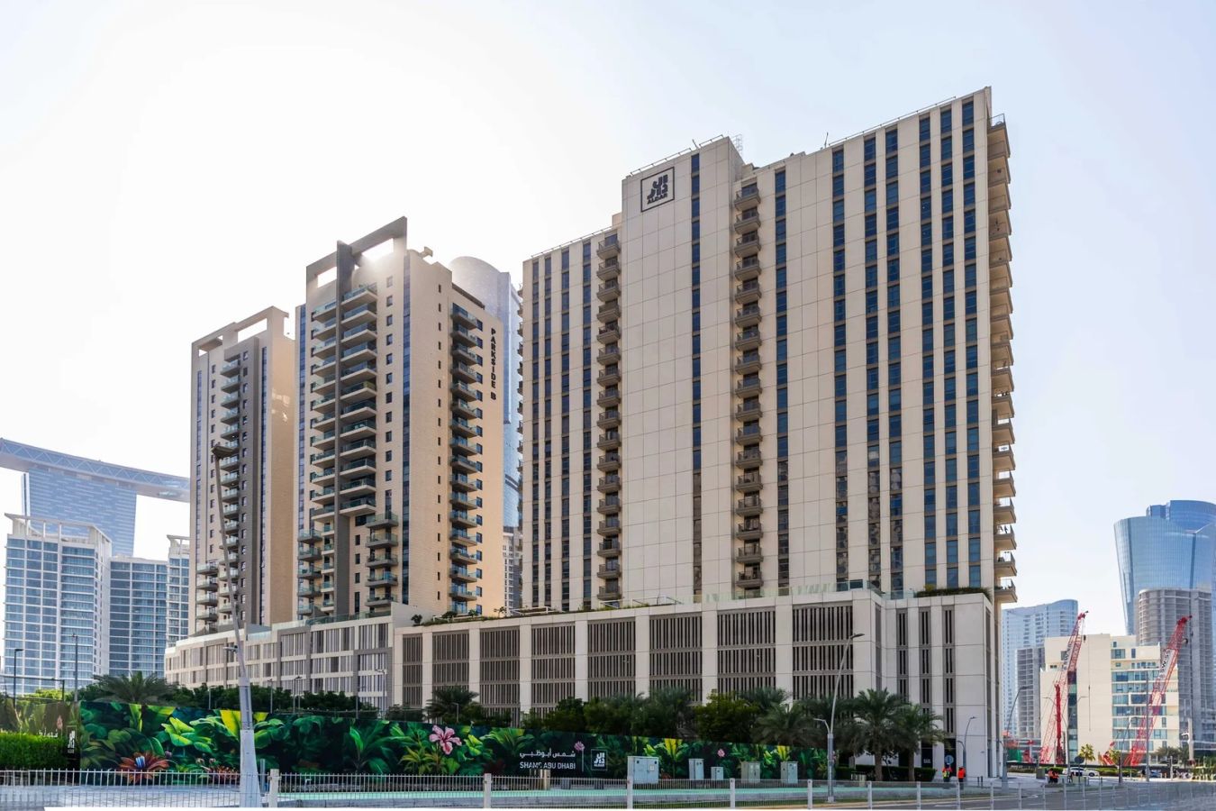Sleek dual glass tower facade of Reflection Towers in City of Lights Al Reem Island Abu Dhabi waterfront development.
